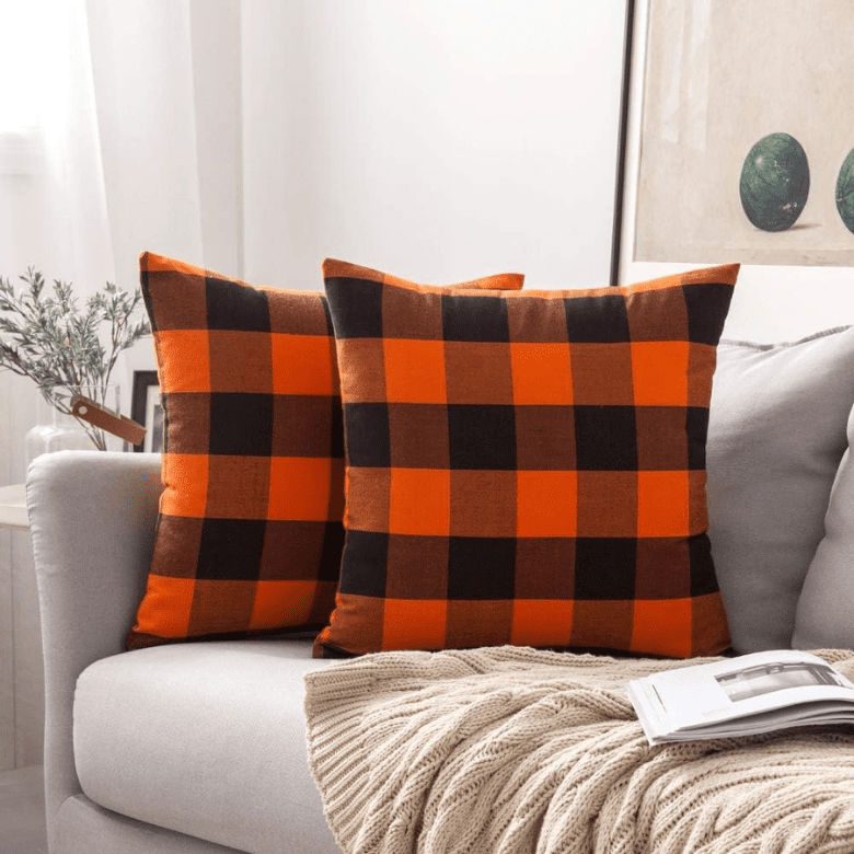 Two throw pillow covers in a classic orange and black buffalo check pattern