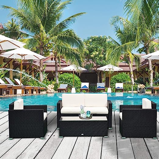 Wicker patio set with white cushions by a poolside