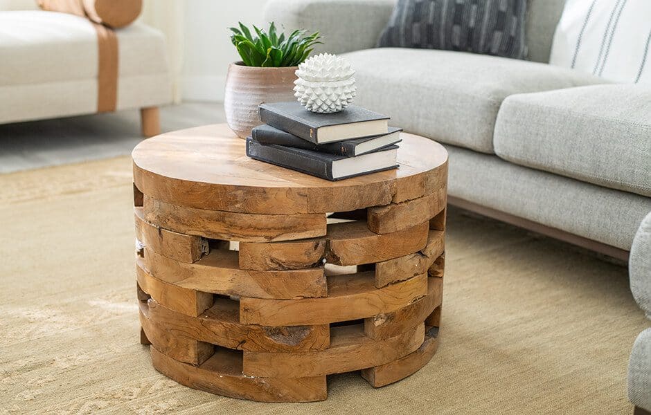 A custom round wooden coffee table with books on top