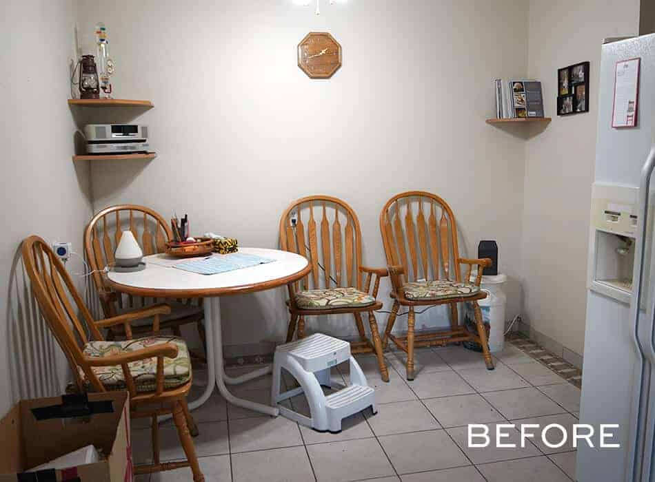 Small dining area with round table and four wooden chairs