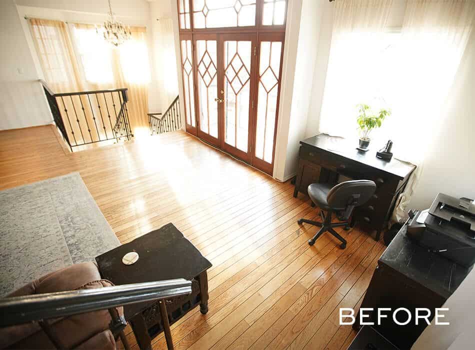 Bright home office with wooden floors, a dark desk, and French doors