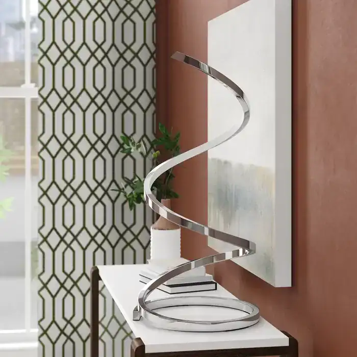 Modern entryway with chrome spiral sculpture, abstract wall art, and green geometric curtains