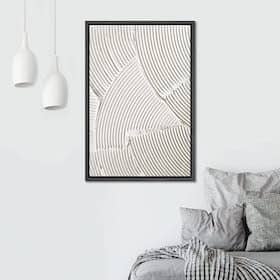 Minimalist bedroom with abstract line art on the wall above a bed with gray pillows and blanket