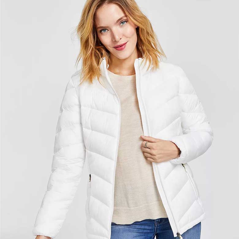 Woman in white puffer jacket and beige sweater