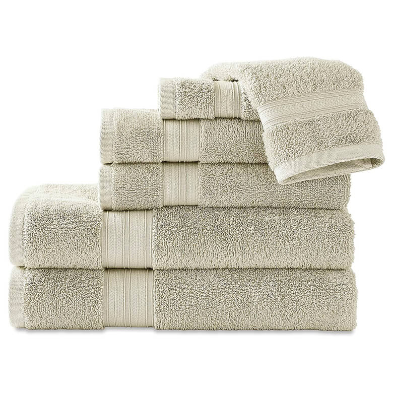 Stack of beige cotton bath towels in varying sizes