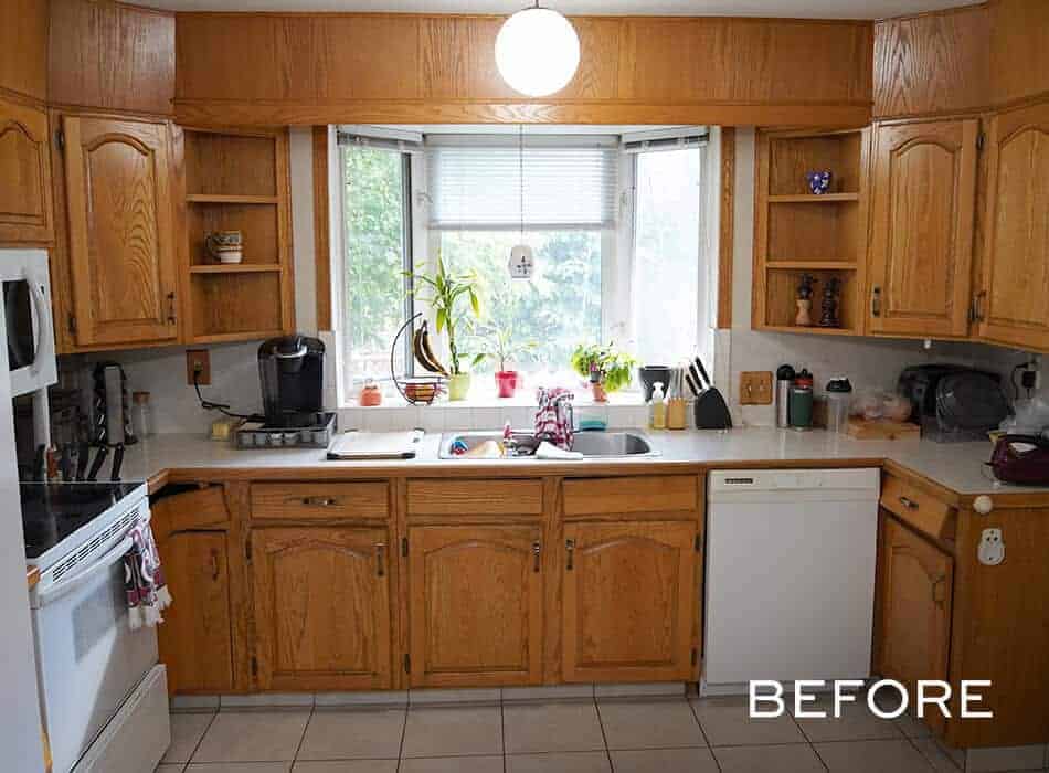 Traditional kitchen with oak cabinets, a bay window, and white countertops