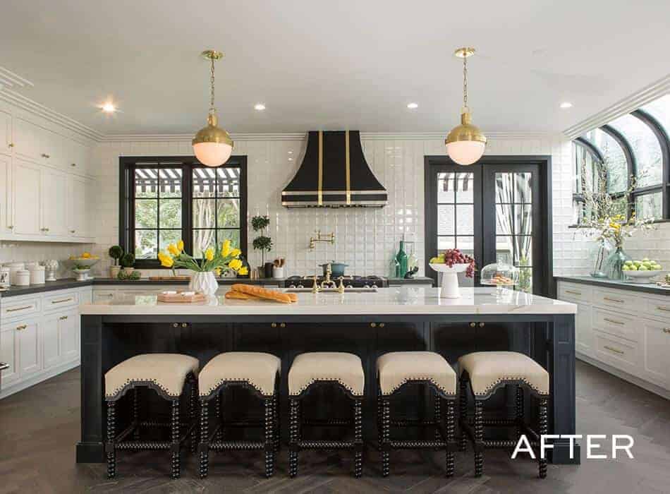 Renovated kitchen with black and white accents, gold fixtures, and large central island