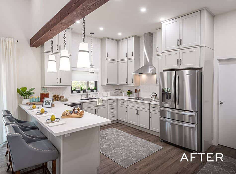An after image of a modern white kitchen with stainless steel appliances, and a center island with barstools