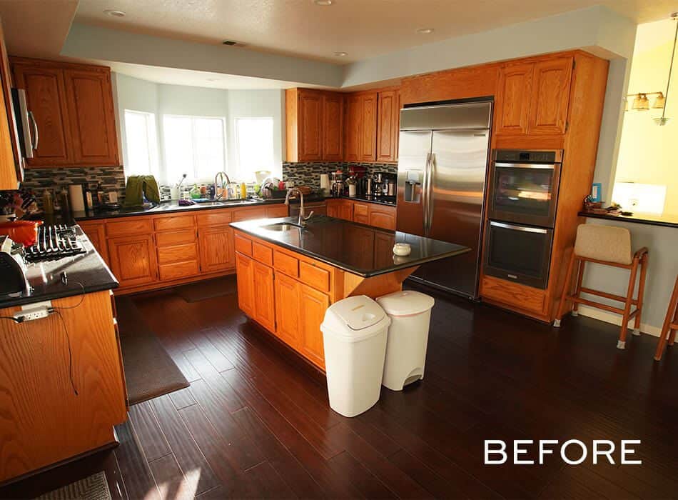 Pre-renovation kitchen with wooden cabinets and an island.