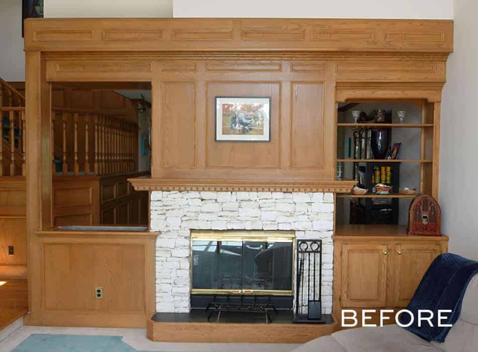 Wood-paneled fireplace with built-in shelves and a stone surround