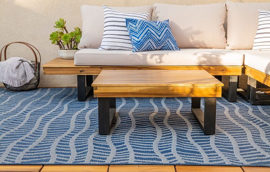 Outdoor seating area with wooden furniture and decorative pillows