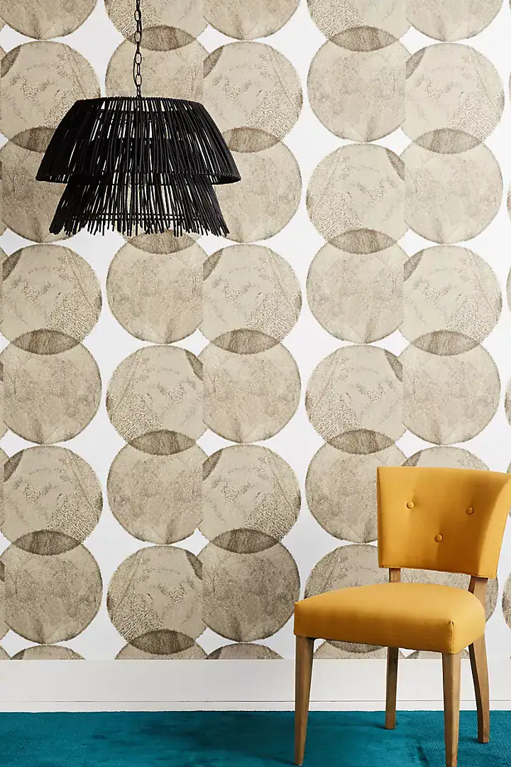 Contemporary interior with a light teal rug on the floor and a mustard yellow chair