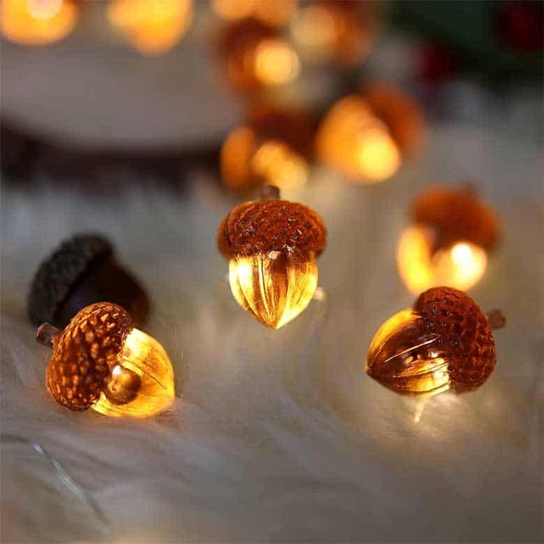 Glowing acorn-shaped string lights on a soft surface