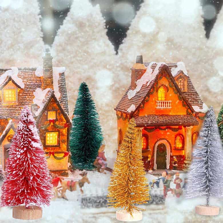 Miniature snowy village with colorful Christmas trees and lit houses