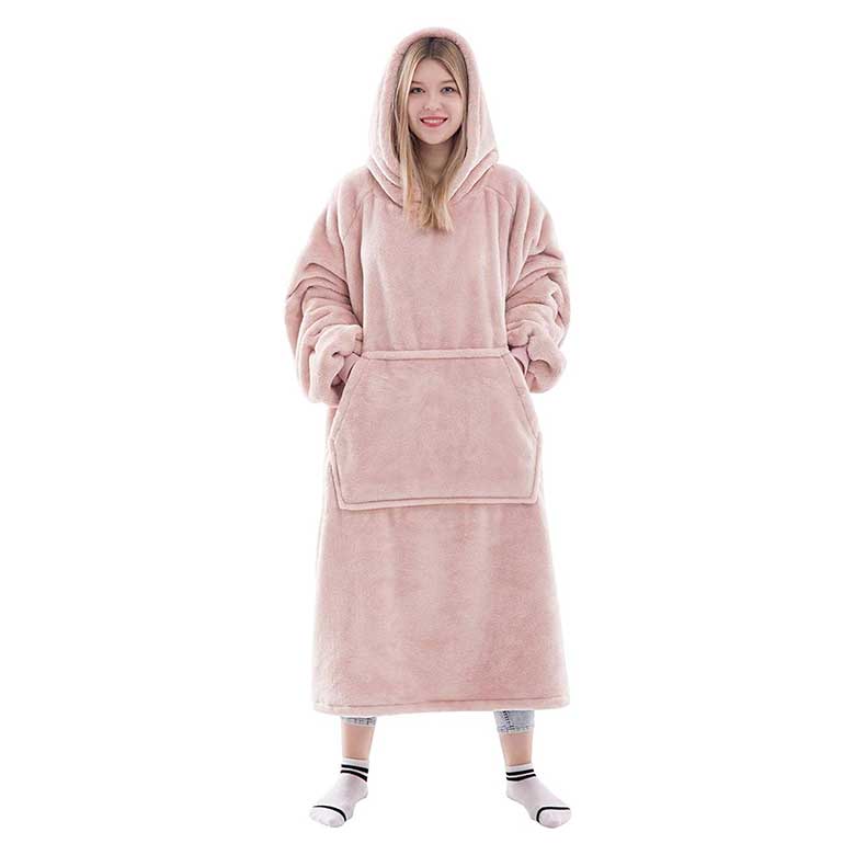 Woman wearing an oversized pink fleece hooded blanket robe