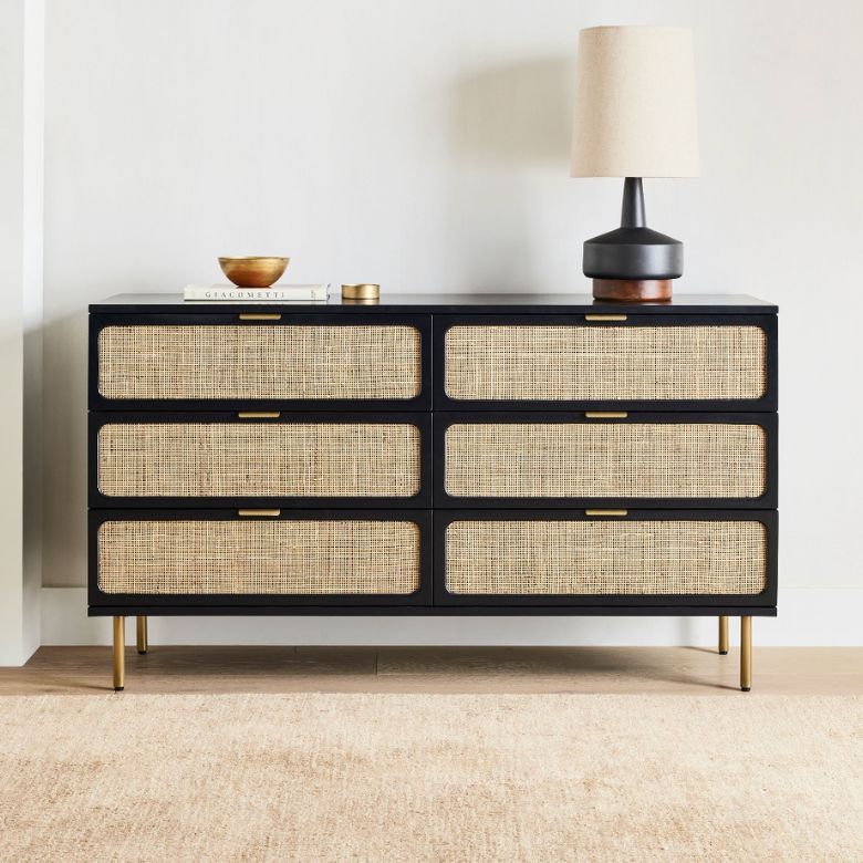 Black dresser with rattan drawers and gold accents