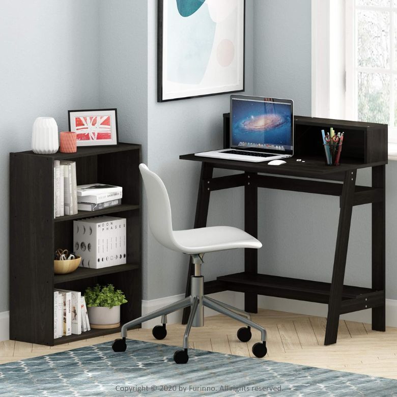 Compact home office setup with dark wood desk, white swivel chair, and small bookshelf.