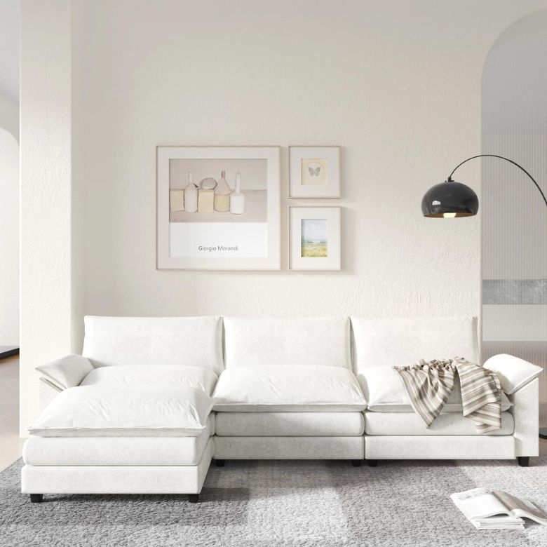 Bright living room with white sectional sofa, wall art, and black arc floor lamp.