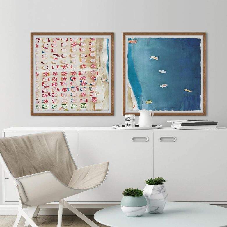 Modern living space with white cabinet, abstract beach-themed wall art, and neutral chair.