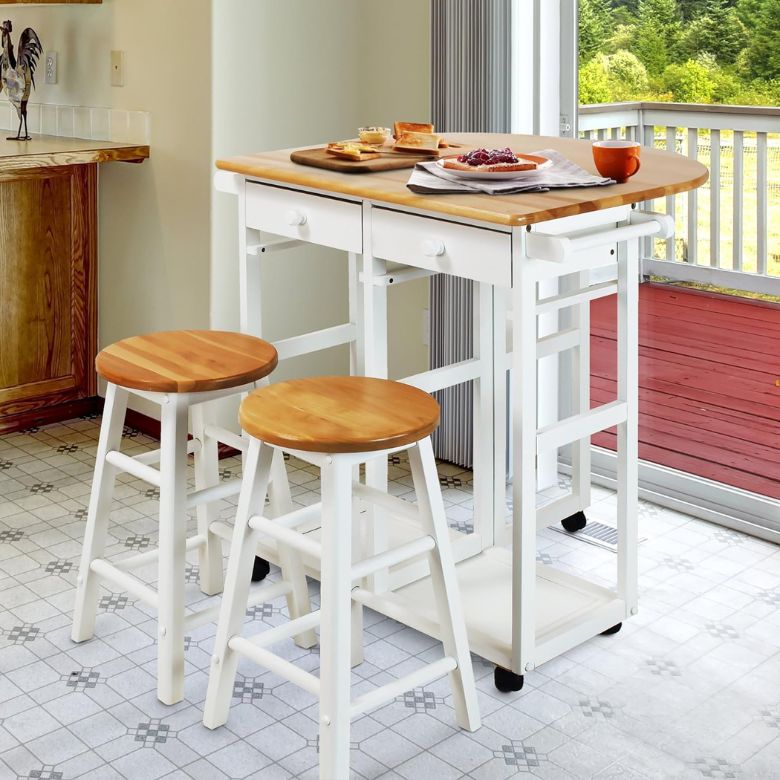 White kitchen island with wooden top and matching stools set for breakfast.