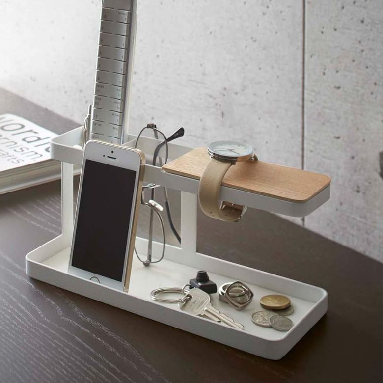 White tabletop organizer holding a phone, glasses, watch, keys, and coins.