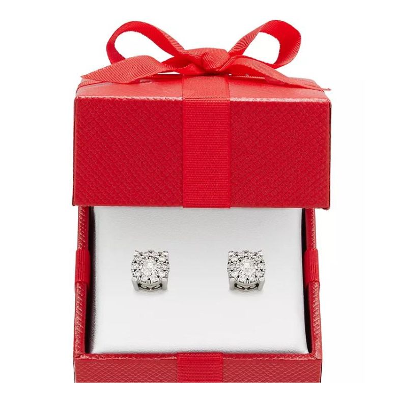 Diamond stud earrings displayed in an open red gift box with a bow.