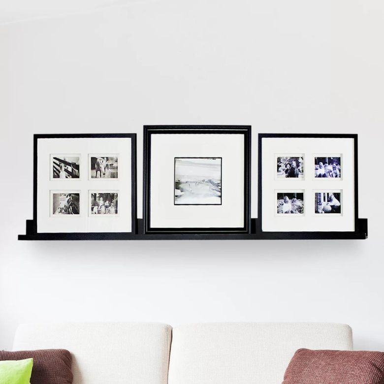 Black photo ledge displaying three framed black-and-white photo collages above a sofa.