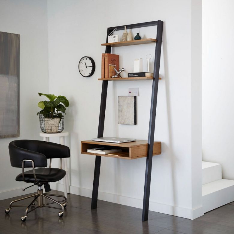 Leaning ladder desk with wooden shelves and a black swivel chair in a minimalist corner.
