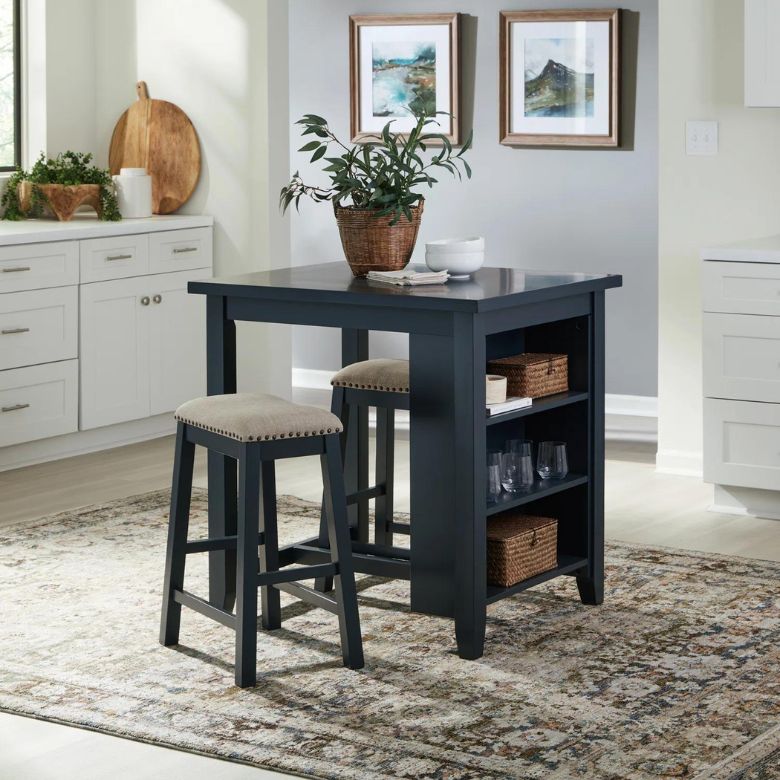 Dark kitchen island table with two upholstered stools and open side shelving in a bright, modern kitchen.