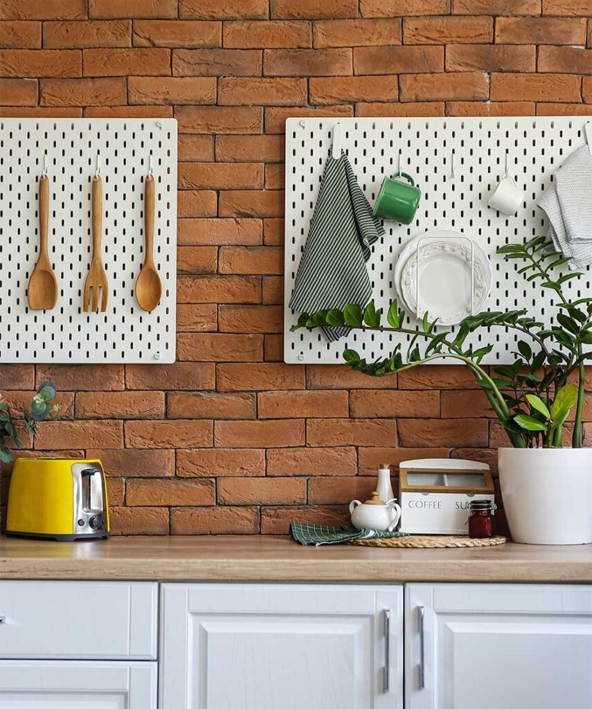 organized kitchen with plates, utensils, rags, and cups