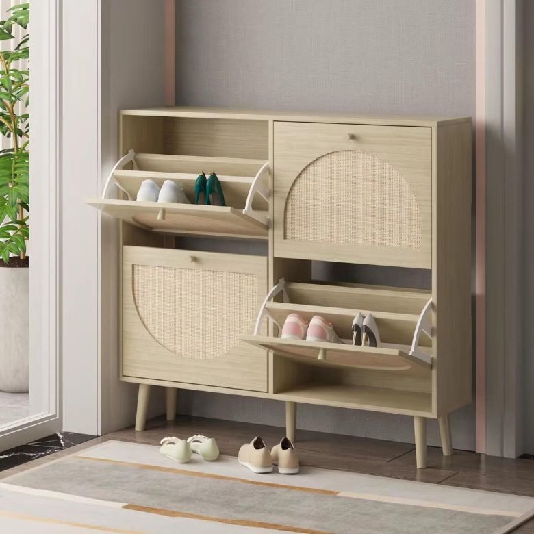 Light wood shoe cabinet with flip-down compartments holding multiple pairs of shoes.