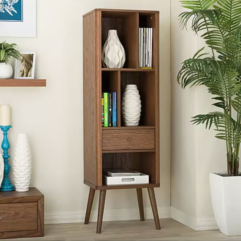 Tall wooden bookshelf with open shelves, books, and decorative vases.