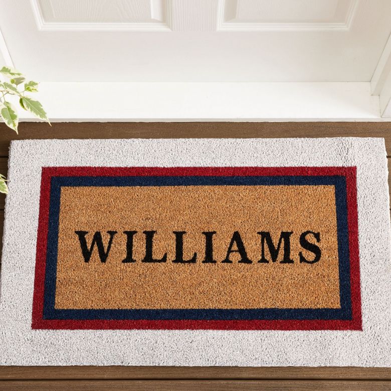Personalized doormat with the name “Williams” in black lettering framed by red and blue borders.