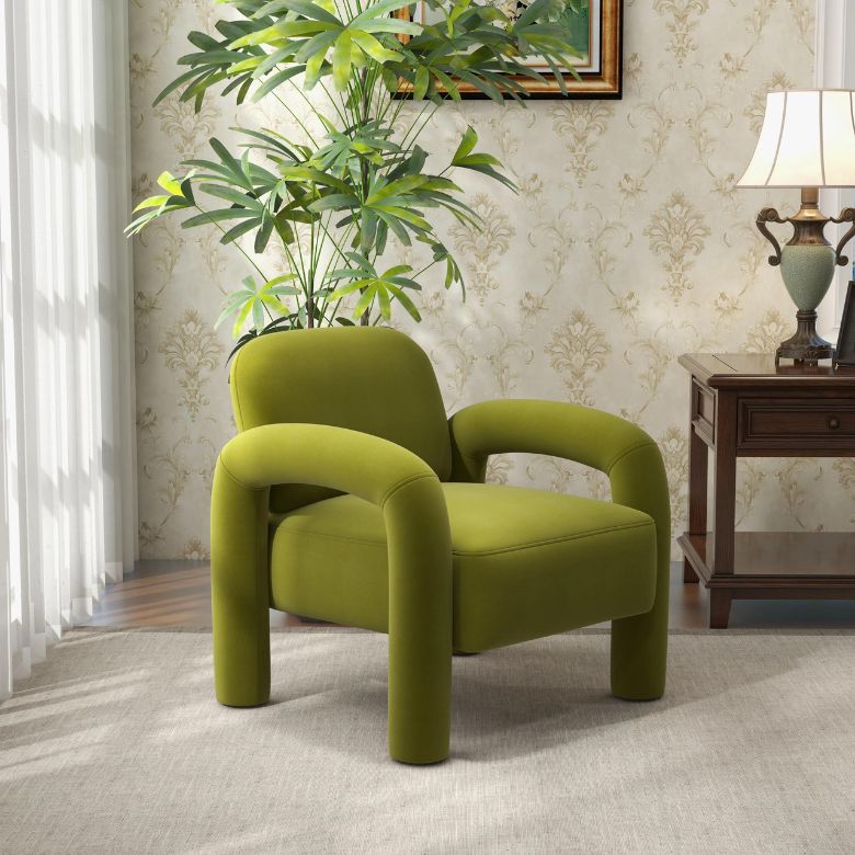 Green upholstered accent chair with rounded arms and legs in a cozy living room corner.