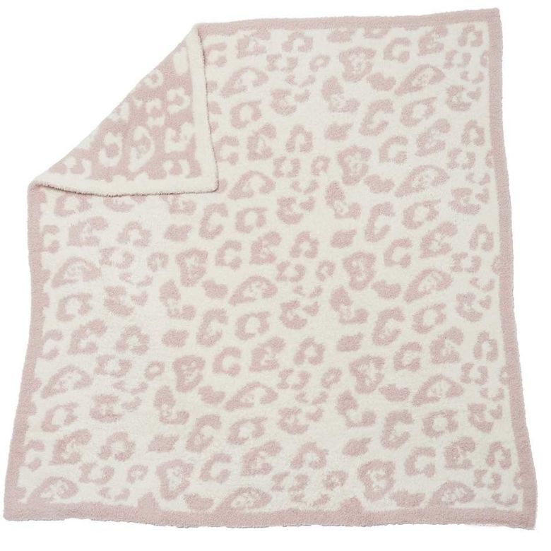 Soft pink and white leopard-print baby blanket with a folded corner.