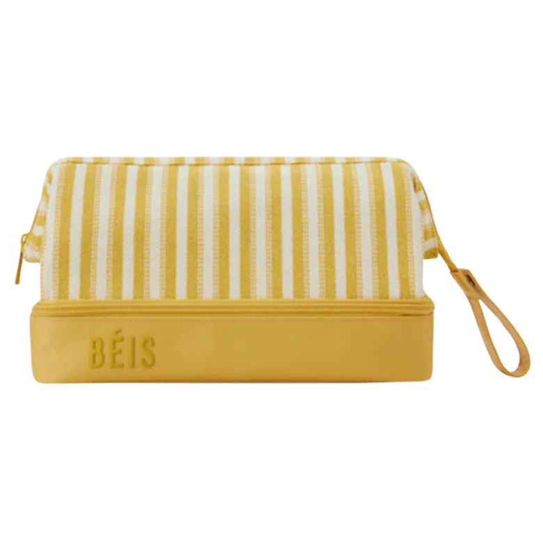 Yellow and white striped BÉIS cosmetic bag with a solid yellow base and wrist strap.