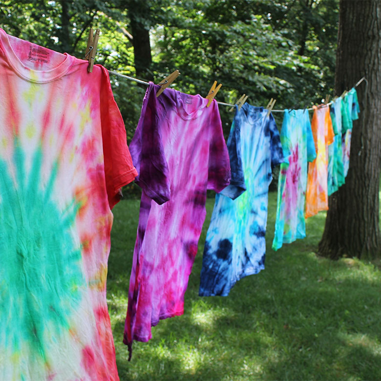 tie dye shirts hanging in the yard