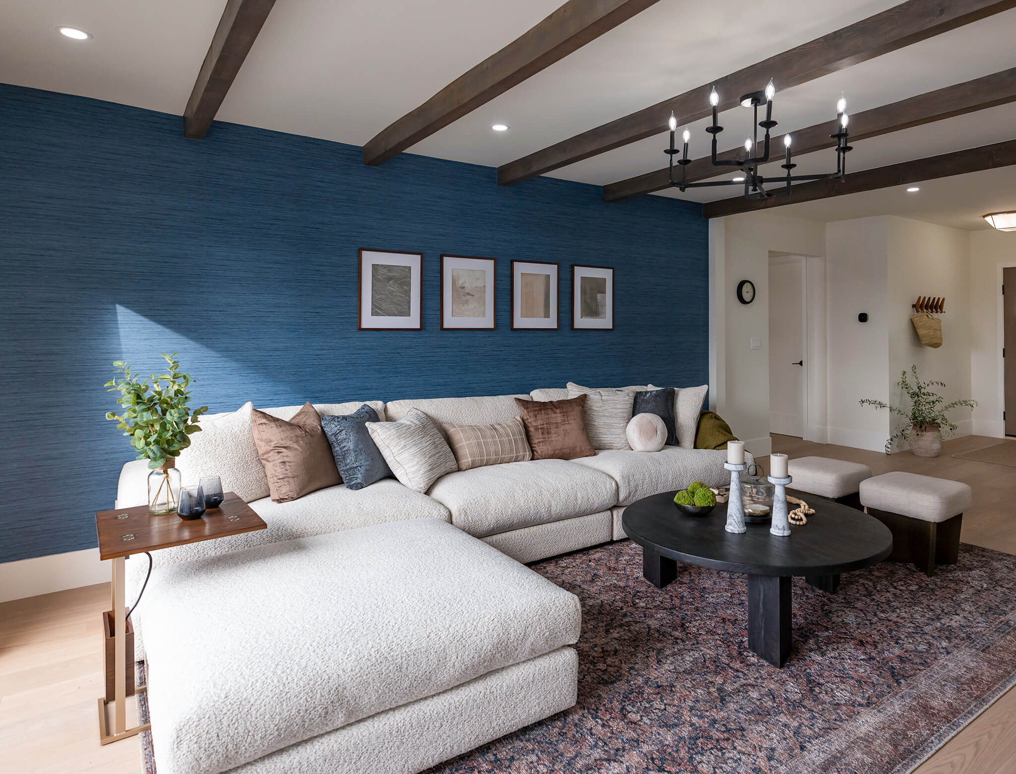 bold blue living room with contrasting beams and big cozy white sofa