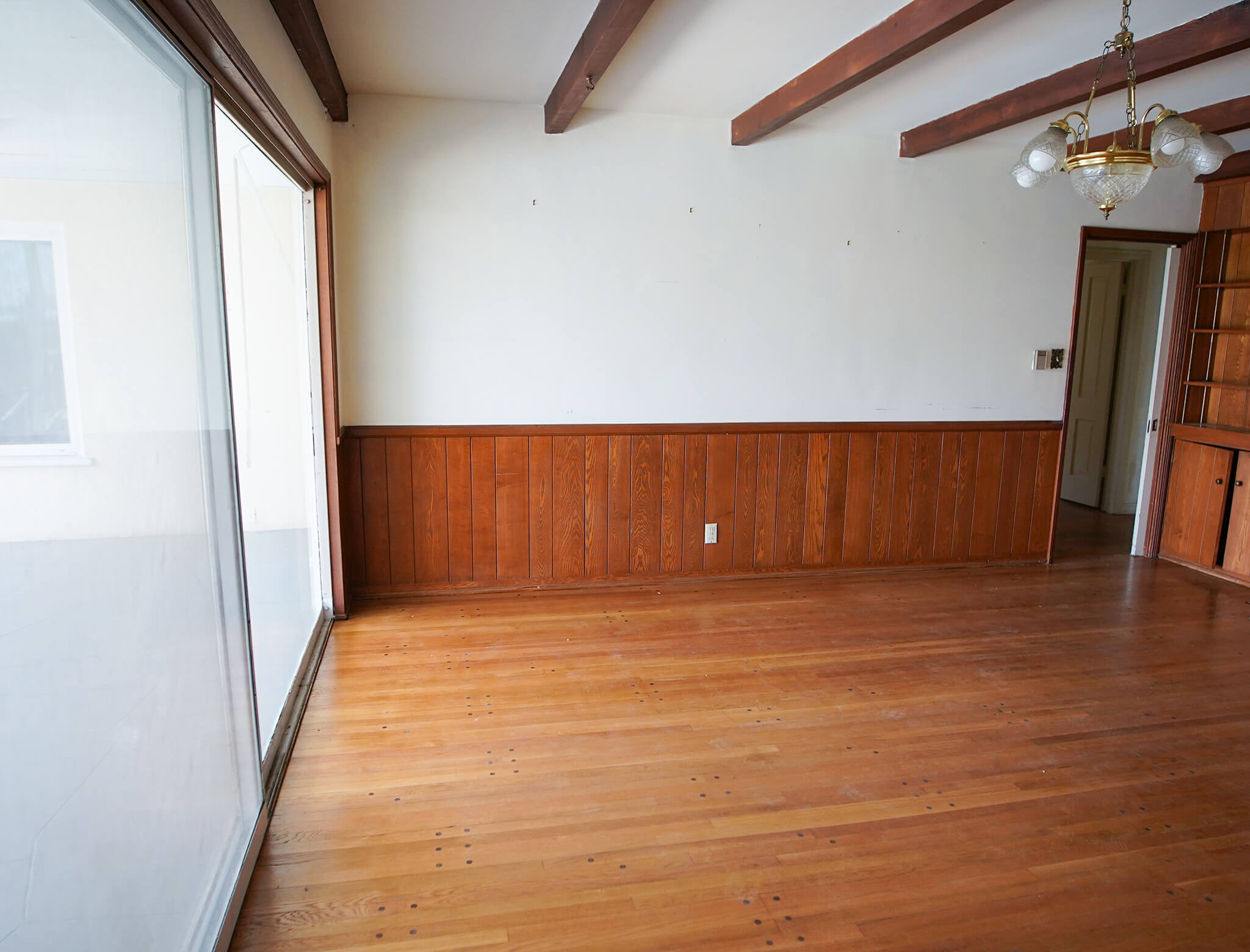old and empty living room with chandelier