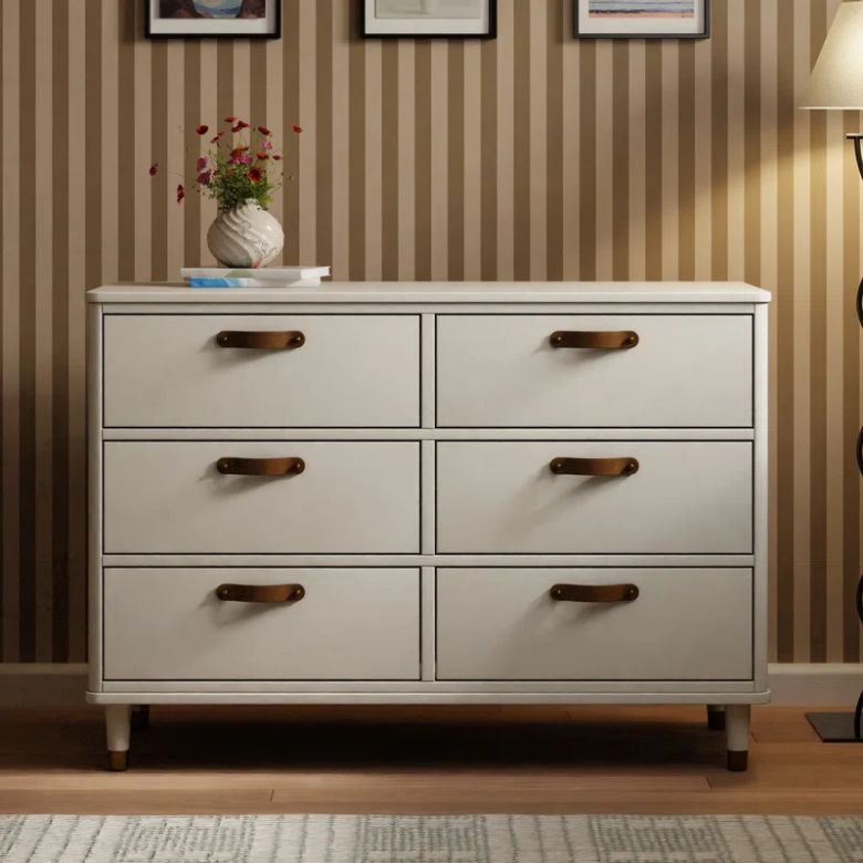 cream colored dresser with leather drawer pulls