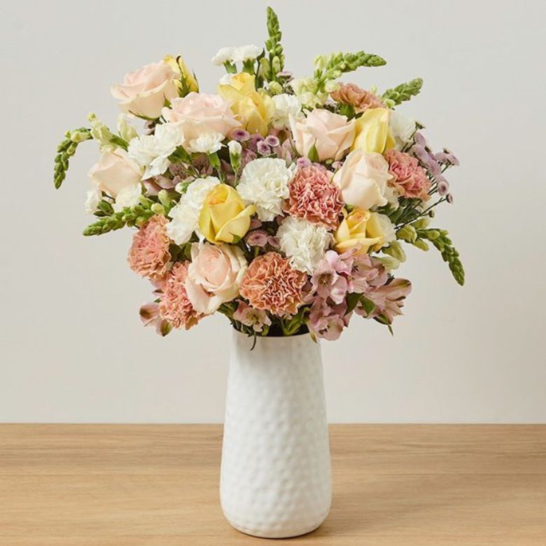 Peach and cream rose bouquet with carnations, alstroemeria, and snapdragons
