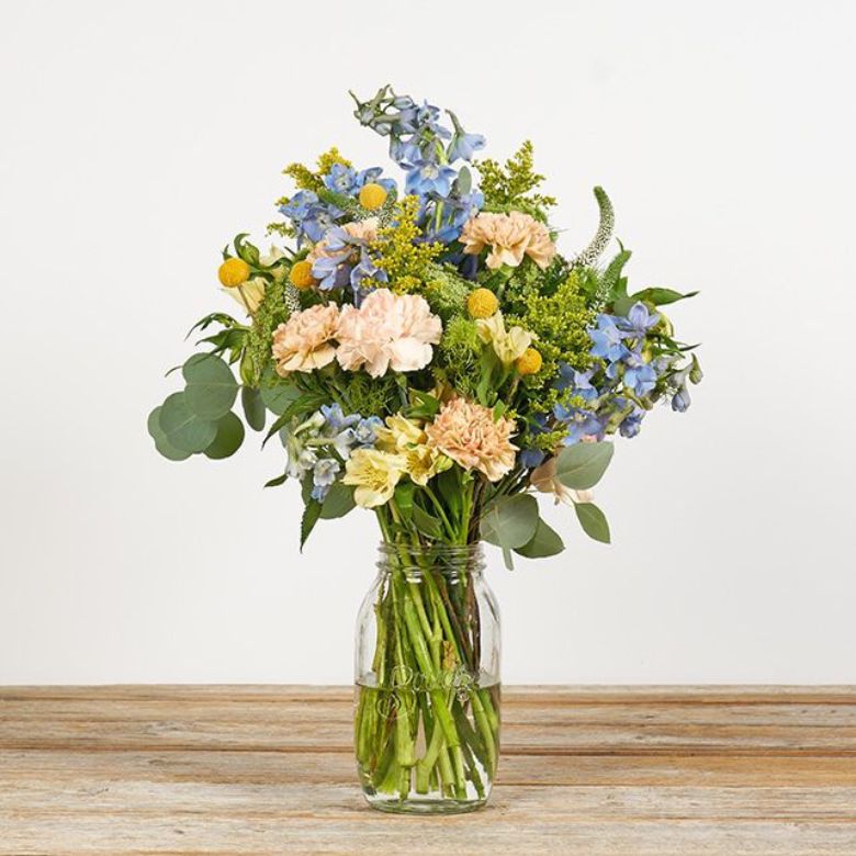 bouquet of pink carnations with alstroes, solidago and delphinium