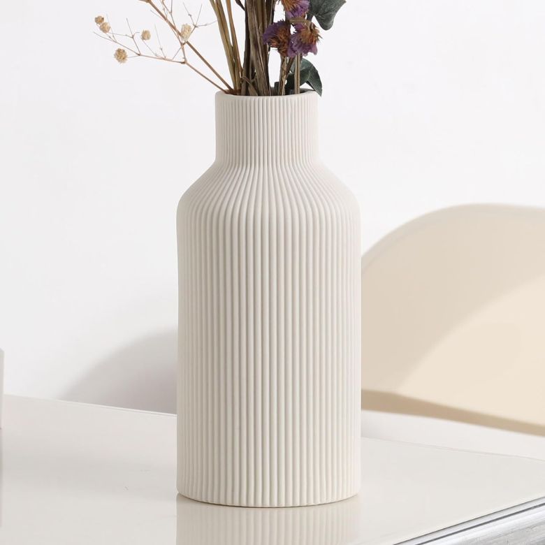 white ceramic ribbed vase
