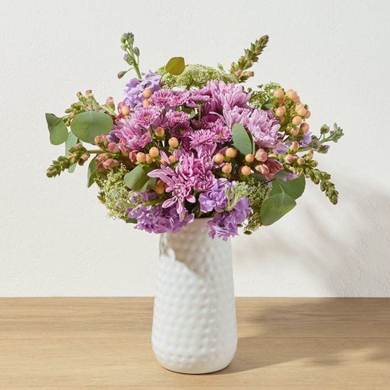 bouquet of snaps, hypericum, and pink and poms in orange, lavender peach, and pink