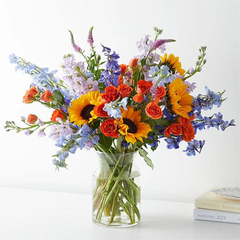 bouquet of sunflowers, roses, and delphiniums