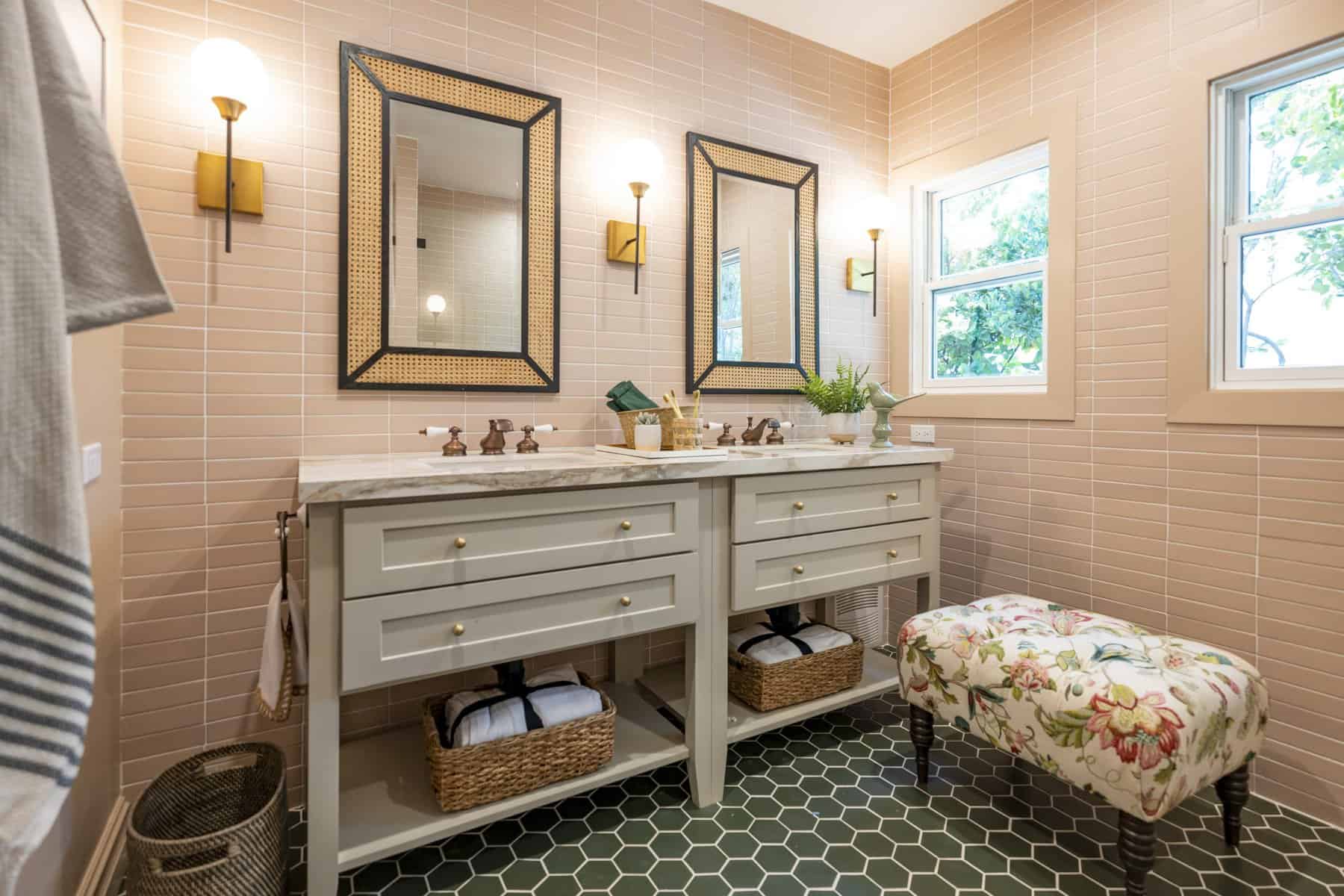 Eclectic bathroom with pink subway tile walls, sage green vanities, and green hex tile flooring