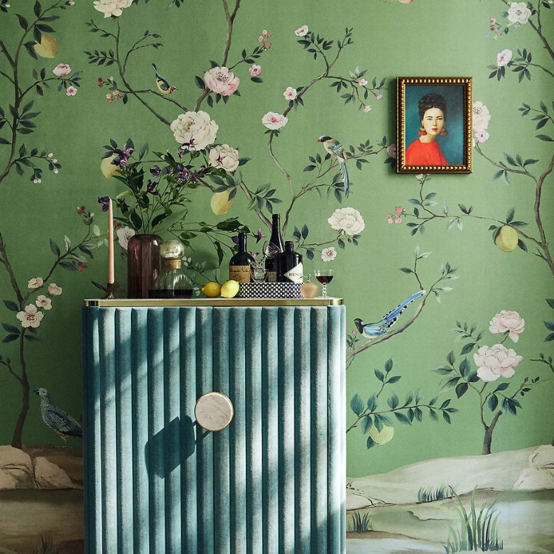 green wallpaper mural featuring twirling chinoiserie