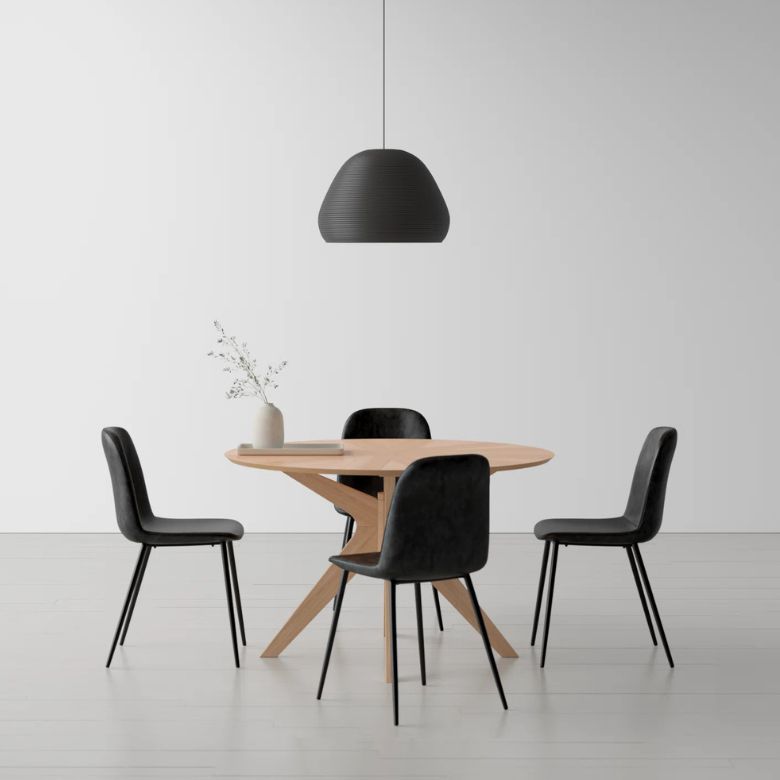 round wooden table with 4 black upholstered dining chairs