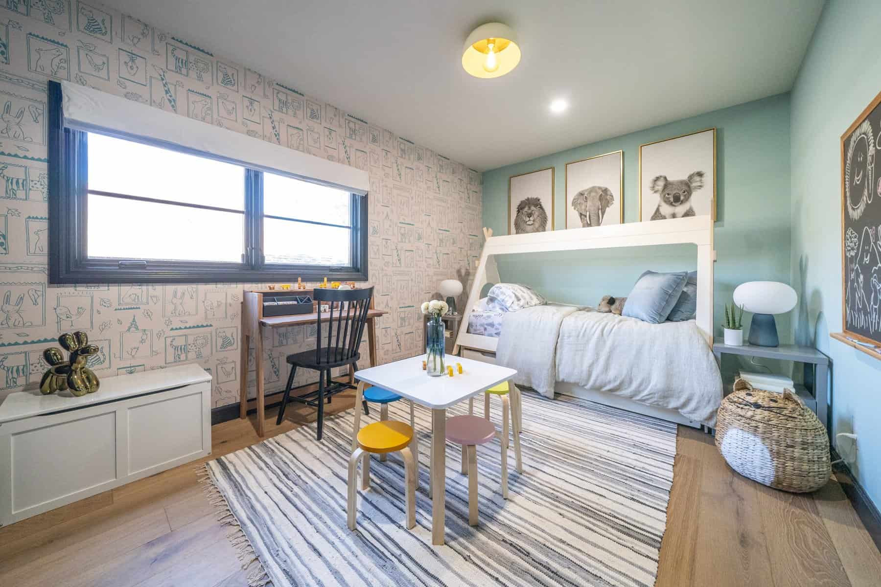 Kids’ bedroom with a loft bed, animal wall art, striped rug, and colorful play table