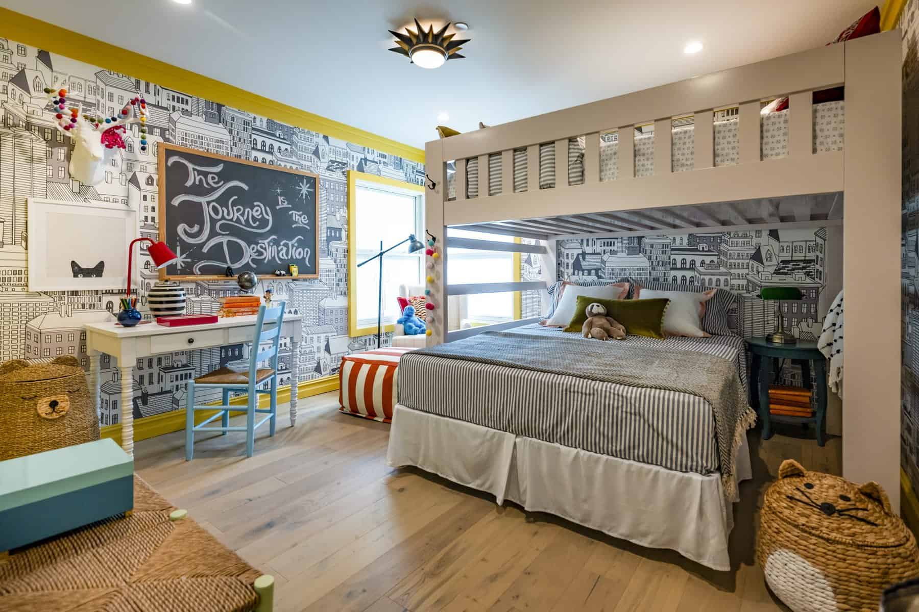 Playful kids' room with a bunk bed, cityscape wallpaper, and a chalkboard message